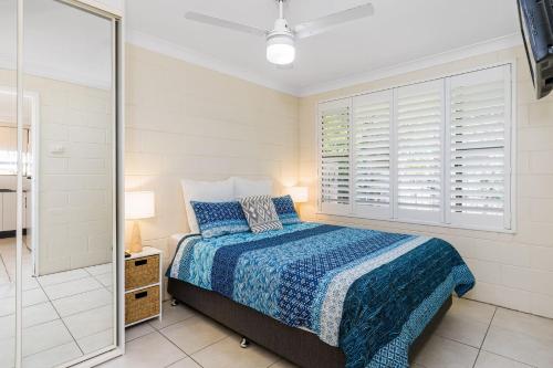 a bedroom with a bed and a glass shower at Iluka Villa 10 in Iluka