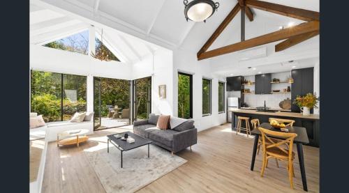 a living room with a couch and a table at Daylesford Lake Garden Villas in Daylesford