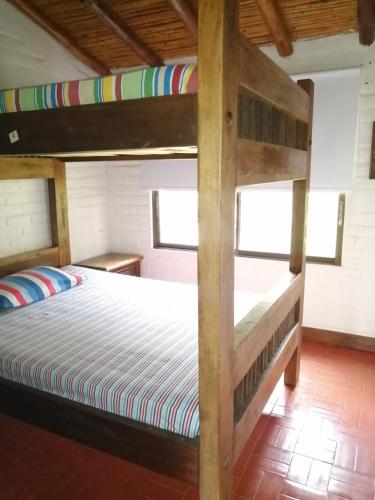 a bedroom with two bunk beds in a room at casa calima in Calima
