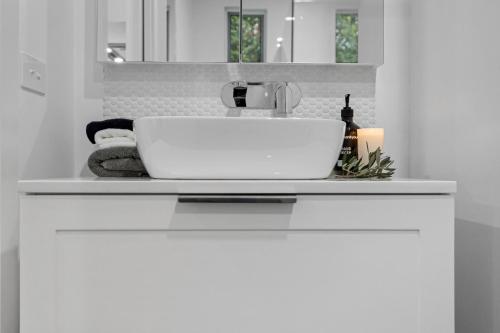 a white sink in a white bathroom with a counter at Capella Villa No. 4 - stunning luxury decor inside and out in Blairgowrie
