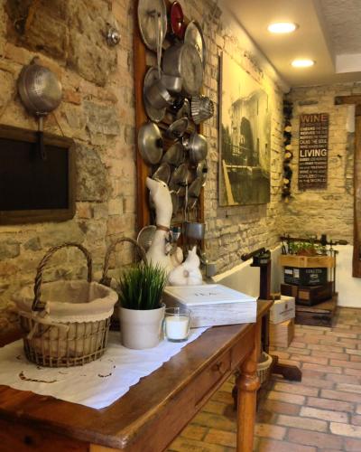 a kitchen with a sink and pots and pans on the wall at Siore Marie gli alloggi in San Giórgio di Nogaro