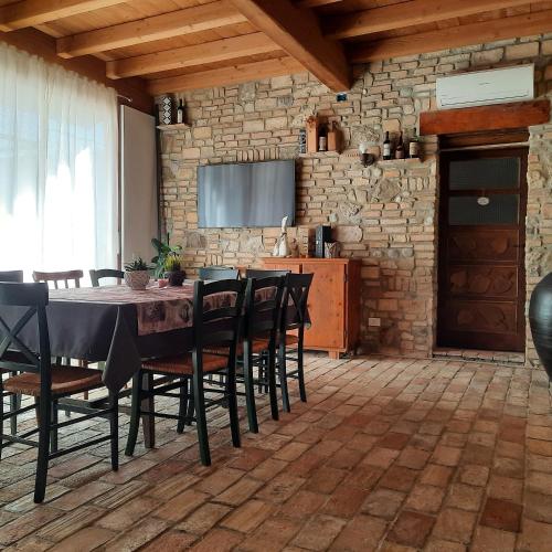 a dining room with a table and chairs at Siore Marie gli alloggi in San Giórgio di Nogaro