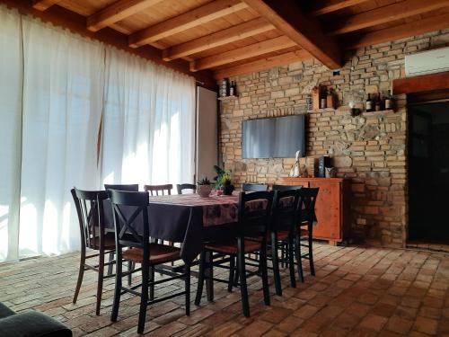 a dining room with a black table and chairs at Siore Marie gli alloggi in San Giórgio di Nogaro