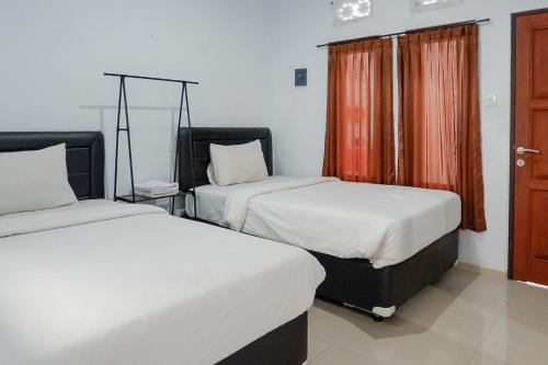 Ένα ή περισσότερα κρεβάτια σε δωμάτιο στο KoolKost near Raya Canggu - Minimum Stay 5 Nights