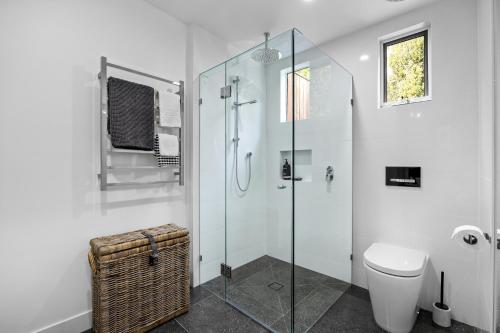 a bathroom with a glass shower stall and a toilet at Capella Villa No. 2 - luxury with outdoor kitchen in Blairgowrie