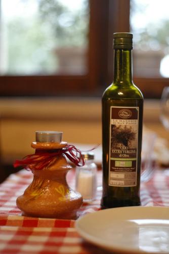 a bottle of wine sitting on top of a table at Le Mandrie Di San Paolo in Assisi