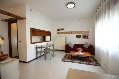 a living room with a red couch and a table at Appartamento CECCATO in Montecchio Maggiore