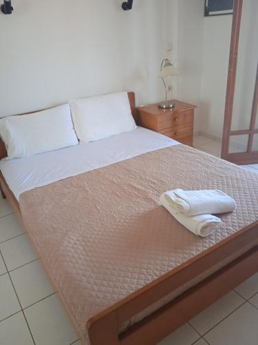 a bed with two towels sitting on top of it at Malia budget in Pírgos