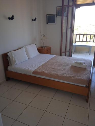 a bed sitting in a room with a window at Malia budget in Pírgos