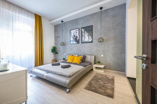 a bedroom with a bed with yellow pillows at Luxury Nova Home next to the New York Café in Budapest