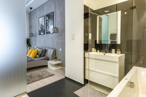 a bathroom with a sink and a mirror at Luxury Nova Home next to the New York Café in Budapest
