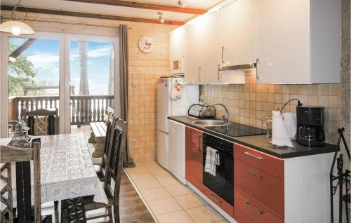 a kitchen with a counter and a table and a balcony at Stunning Home In Ostrda With 2 Bedrooms And Wifi in Ostróda