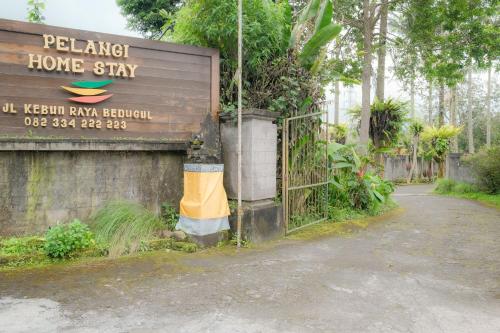 a sign that says peleng home stay next to a gate at Pelangi Homestay Bedugul RedPartner in Bedugul