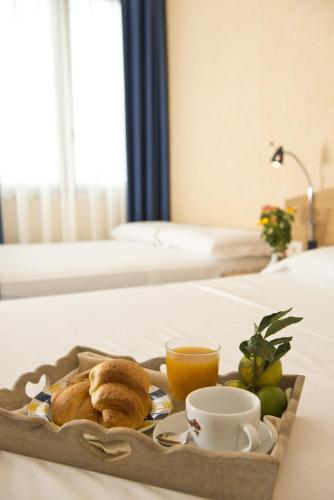 a tray of breakfast foods and coffee on a bed at Park Hotel Sant'Elia in Fasano