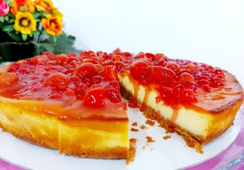 a piece of cake with cherries on a plate at Hotel Senza Pensieri Riccione in Riccione