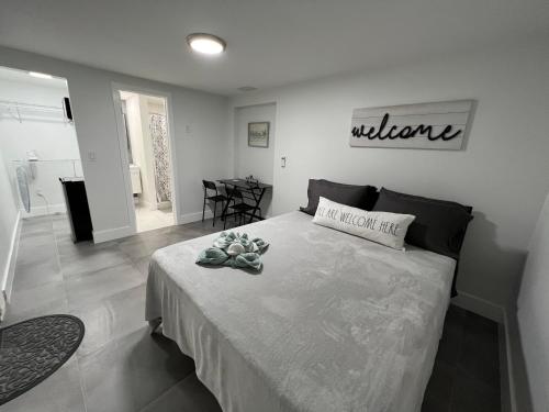 a bedroom with a bed with a welcome sign on the wall at LYZ Miami Airport in Miami