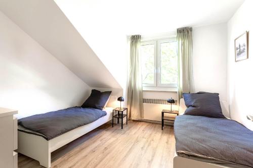 a bedroom with two beds and a window at Cozy 4 room apartment in Hilden in Hilden