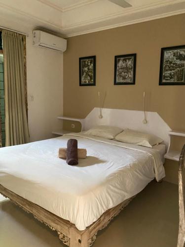 a bedroom with a large white bed with a hat on it at Blue Lagoon 5 bedrooms Villa in Kuta