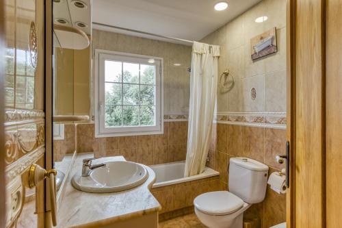 a bathroom with a sink and a toilet and a tub at Villa Casa Dolores Style Catalan in Begur
