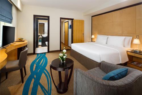 pokój hotelowy z łóżkiem i salonem w obiekcie Savoy Suites Hotel Apartment - Newly Renovated w Dubaju