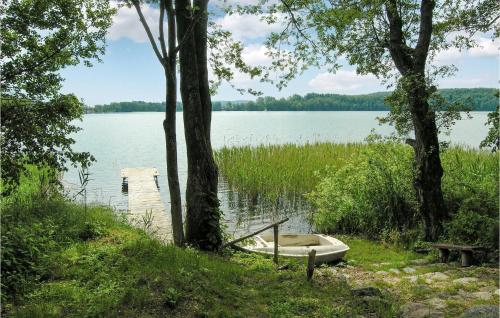 a boat sitting on the shore of a lake at Holiday Home Gietrzald Sila in Olsztyn - Siła