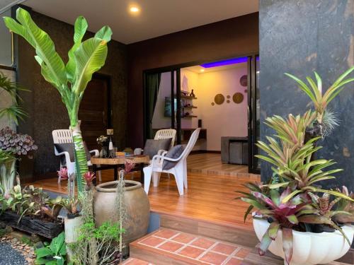 a living room filled with lots of potted plants at Smile Home Krabi Klong Moung Beach in Klong Muang Beach