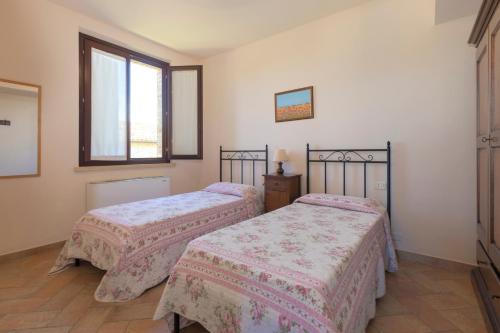 a bedroom with two beds and a window at Casale del Conero in Porto Recanati