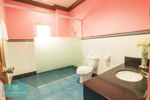 a bathroom with a toilet and a sink at Estancia Resort Hotel in Tagaytay