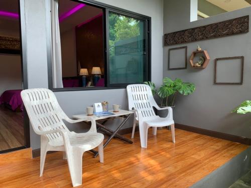 two white chairs and a table in a room at Smile Home Krabi Klong Moung Beach in Klong Muang Beach