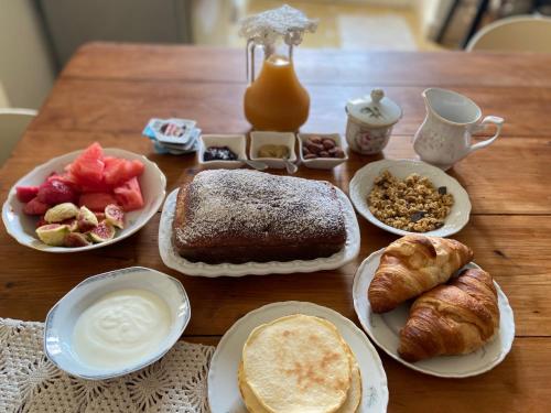 a table topped with plates of food and pastries at Palazzo Vecchio Cocumola in Cocumola