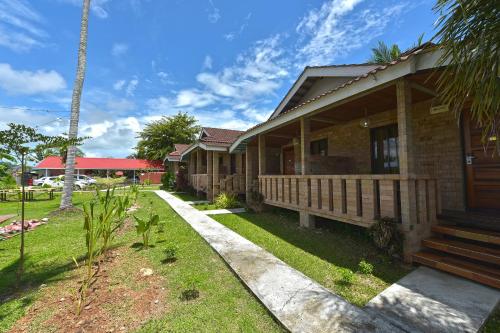 a house with a porch and a pathway to it at Collection O 90622 Sehijau Cenang in Pantai Cenang