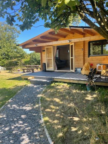 a log cabin with a porch and a patio at The Gallows in Pembroke
