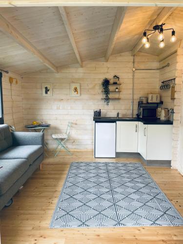 a living room with a couch and a kitchen at The Gallows in Pembroke