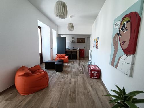 a living room with an orange couch and a table at Nuvoleinviaggio in Sulmona
