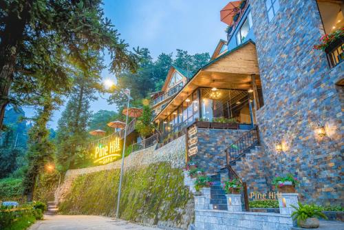 a building with a sign on the side of it at Sapa Pine Hill Eco Lodge in Sa Pa