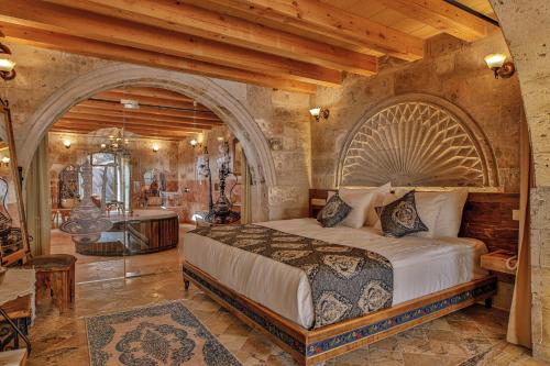 a bedroom with a large bed in a room at Şah Saray Cave Suites Halal Hotel in Göreme