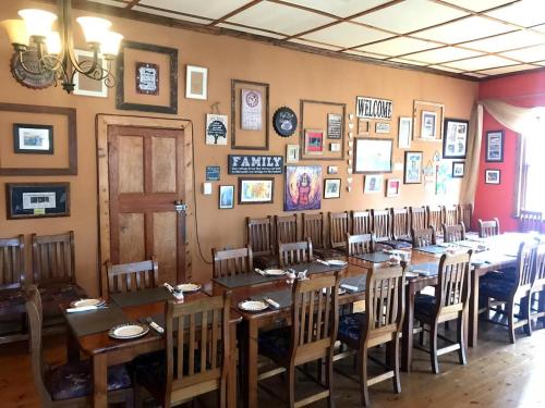 a dining room with a long table and chairs at Eastwoods Lodge in Springs