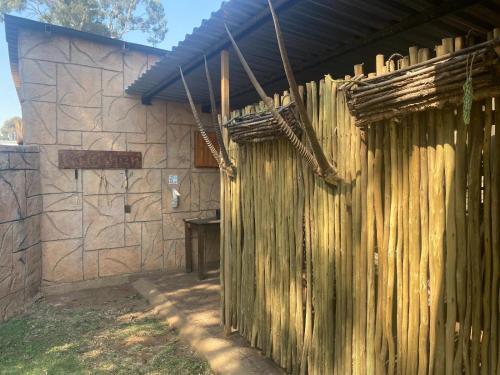 a building with a wooden fence in front of it at Eastwoods Lodge in Springs