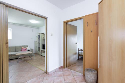 a hallway with a sliding glass door and a living room at Apartment Buzet 17562a in Buzet
