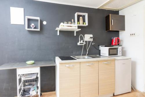 a kitchen with a sink and a black wall at Apartments with a parking space Buzet, Central Istria - Sredisnja Istra - 17333 in Buzet