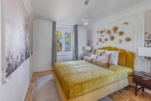 a bedroom with a large bed with a yellow bedspread at Bon Port 1-bedroom apartment – Lakefront in Territet