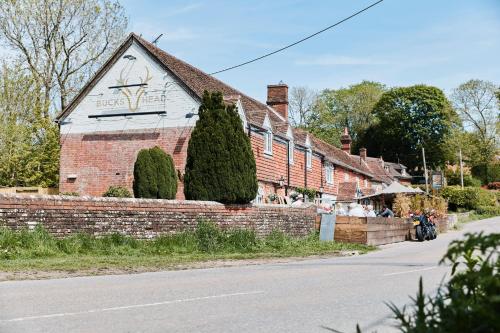 a brick building on the side of a street at The Bucks Head in Meonstoke