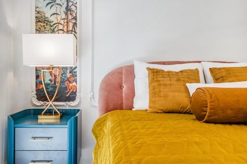 um quarto com uma cama e uma mesa de cabeceira azul com um candeeiro em Tropical studio with a balcony - Lake View em Territet