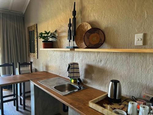a kitchen with a sink and a counter top at Fever Tree Guesthouse in Hillcrest