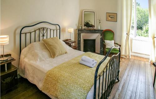 a bedroom with a large bed and a fireplace at Logis De Chenevire in Juignac