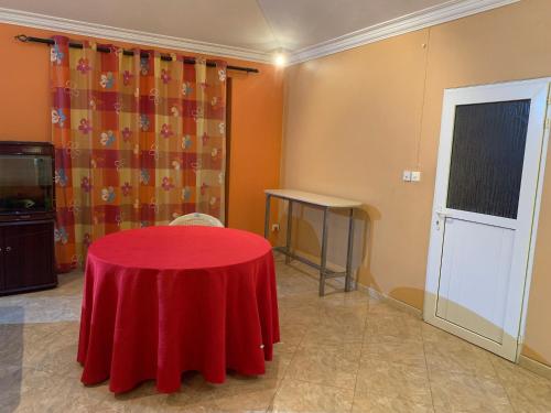 a room with a table with a red table cloth on it at Luxurious house at Coromandel in La Rotraite