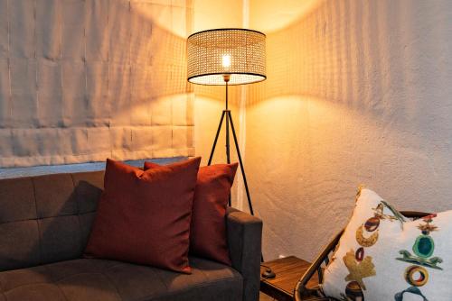 a living room with a couch and a lamp at Fever Tree Guesthouse in Hillcrest