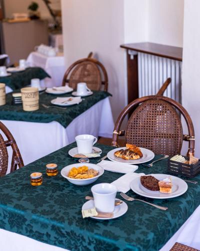 a green table with plates of food on it at Hotel Villa Bonelli in Fiesole