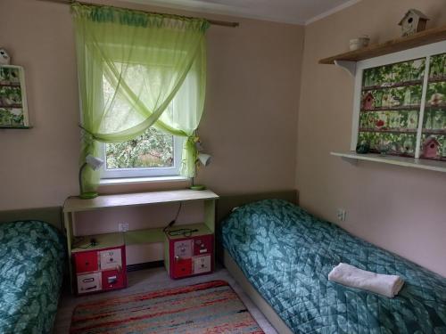 - une chambre avec 2 lits et une fenêtre dans l'établissement Dom Zegarmistrza, à Mirosławiec
