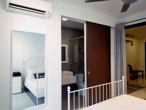 a bedroom with a white bed and a bathroom at H2O Retreat Studio Home 5min to LRT by Premium Stay in Petaling Jaya